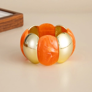 Detailed view of the orange marble resin and gold CCB block elastic bracelet