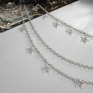 Close-up of punk multi-layer silver pants chain with star charms and vintage texture