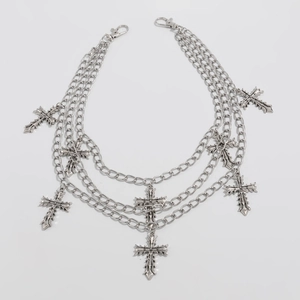 Close-up of triple-layered silver metal pants chain with engraved cross charms