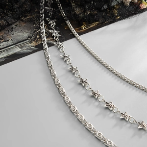 Close-up of punk style multi-layer metal trousers chain with stars and gothic link details