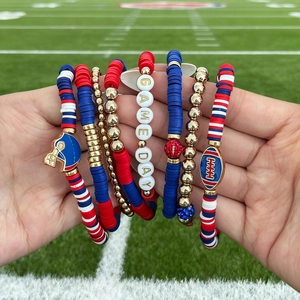 Detail of multi-layer beaded bracelet set with GAME DAY letter beads and sports charms