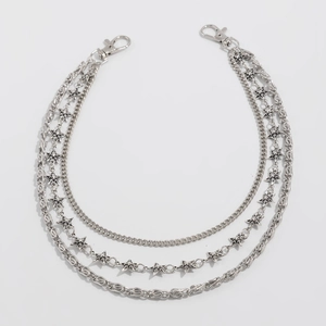 Detail of silver multi-layer punk chain with stars and metal lobster clasps for jeans