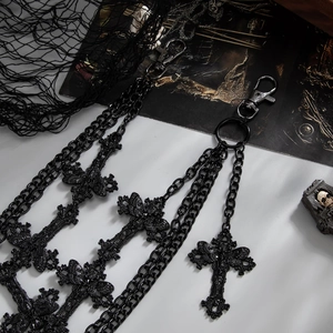 Detail of gothic multi-layer black metal pants chain with cross pendants and lobster clasps