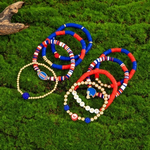 Detail of football-themed stretch bracelets with GAME DAY beads on green moss background