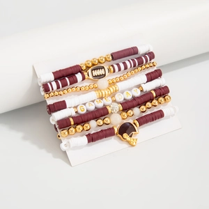 Detail of layered beaded bracelets with football charms and Game Day letter beads