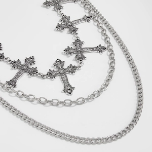 Detail of silver multilayered waist chain featuring vintage engraved hollow cross charms