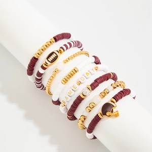 Detail of multi-layer beaded bracelets with Game Day charms and football theme