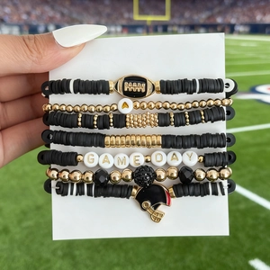 Detail of beaded football bracelet set with Game Day charms and acrylic heishi beads