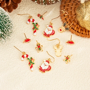 Detail of Christmas earring set featuring Santa, reindeer and candy cane motifs