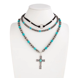 Detail of triple-layer necklace with turquoise beads and antique silver cross pendant