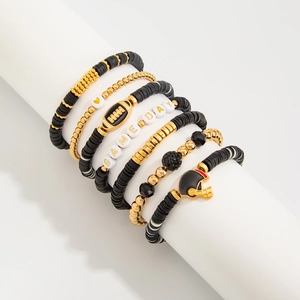 Detail view of five-piece sports-themed bracelet set with GAME DAY beads and helmet charms