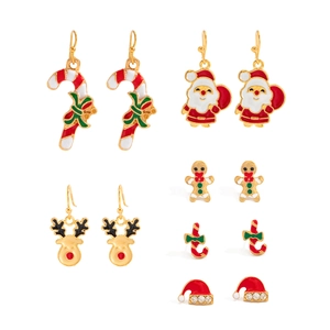 Detail of Christmas earring set featuring Santa, reindeer, and gingerbread motifs