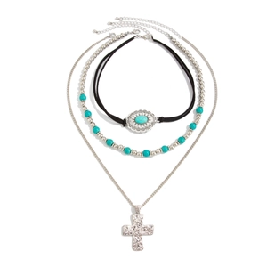 Detail of layered Bohemian necklace set with turquoise beads and silver cross pendant