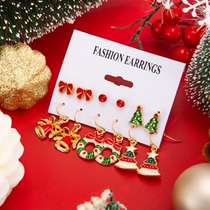Detail of 6-pair Christmas earring set with Santa, reindeer, and bells in a festive display