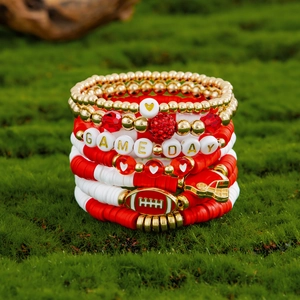 Detail of Game Day bracelet set with acrylic beads, football charms and red crystal beads