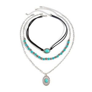Detail of bohemian layered necklace with turquoise beads and retro silver pendants