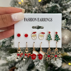 Detailed set of six Christmas earrings featuring Santa, snow, and holiday trees