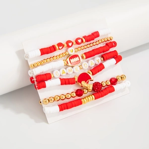 Close-up of Game Day beaded bracelet set with red football helmet and golden charms