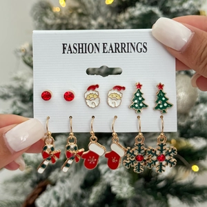 Detail view of a 6-pair Christmas earring set with Santa Claus and snowflake designs