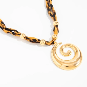 Detail of heart pendant necklace with leopard print fabric and golden beads