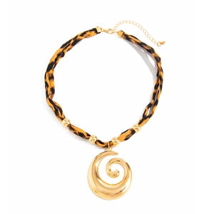 Macro view of leopard print fabric chain with golden spiral pendant and lobster clasp detail