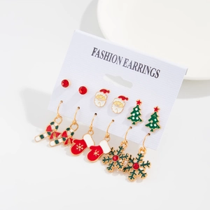 Close-up of 6-pair Christmas earring set with enamel Santa Claus and snowflake charms
