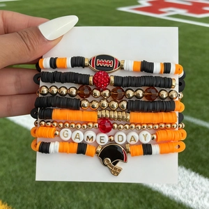 Macro shot of Game Day acrylic beaded bracelets with football charms on a white card