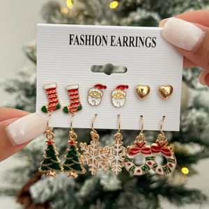 Detailed view of 6 pairs of festive Christmas earrings including Santa and snowflakes