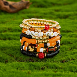 Multi-layer orange and black beaded bracelet set with Game Day charms and football helmet