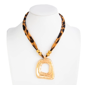 Detail of leopard print fabric choker with large textured gold geometric pendant