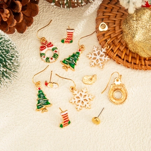 Macro shot of Christmas earrings collection featuring enamel trees, snowflakes and wreaths