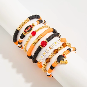 Detail of 6-piece Super Bowl themed elastic bracelets featuring Game Day beads and charms