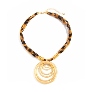 Detail of leopard print fabric necklace with gold matte concentric circle pendant