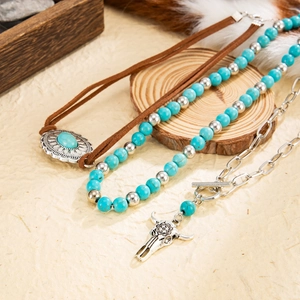 Bohemian layered necklace featuring turquoise stones, beads, and an ox head pendant detail