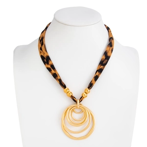 Detailed macro view of leopard print fabric strap and multilayer gold concentric circles
