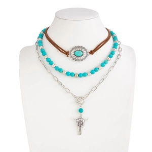 Detail of bohemian layered necklace featuring faux turquoise beads and bull skull pendant