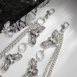 Close-up of gothic silver moth and skull layered chain belt with metal clasp