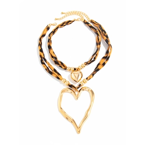 Detail of double-layer necklace featuring leopard print fabric and large gold heart pendants