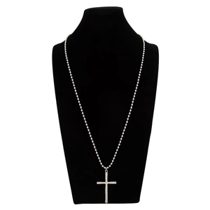 Detail of silver beaded cross necklace displayed on a professional black neck bust