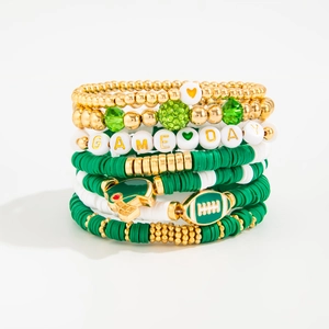 Detail of stacked football bracelets featuring green crystals and Game Day letter beads