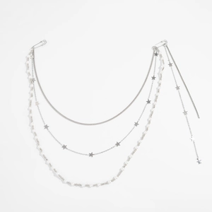 Detail of multi-layer silver pant chain with stars and pearls using safety pin clasps