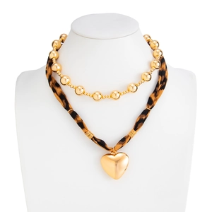 Golden bead necklace with leopard print scarf wrap and large polished metal heart pendant