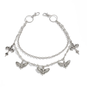 Close-up of gothic silver trousers chain with skull moth and cross charms detail