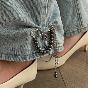 Fashion heart pendant brooch with multi-layer tassel chain on blue denim jeans
