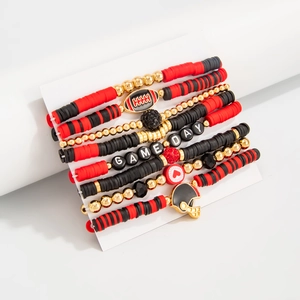 Detail of five stackable Game Day beaded bracelets with football charms and heishi beads