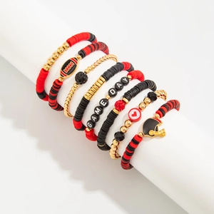 Macro view of 7-piece Super Bowl beaded bracelet set with Game Day charms and football theme