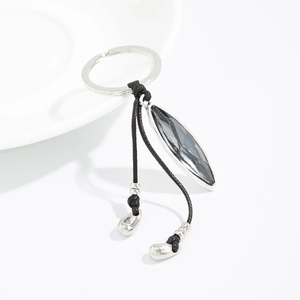 Detail of dark grey leaf-cut faceted gemstone keychain with silver metallic accents