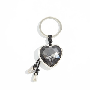 Detail of heart-shaped acrylic crystal keychain with black woven rope and silver metal frame