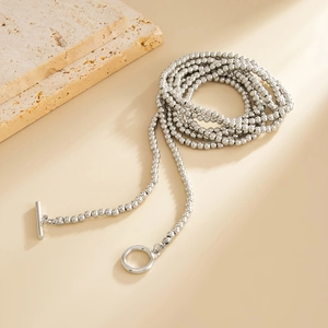 Detail van zilveren kralenketting met een stijlvolle OT-knevelsluiting op een textuursteen
