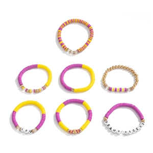 Detail of purple and gold beaded bracelets with LSU and GEAUX TIGERS letter beads